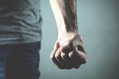 a man's fist balled up by his side - violent crimes